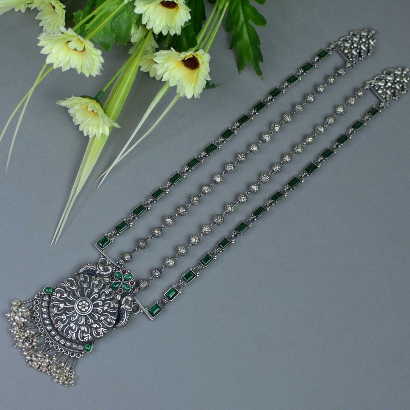 long silver necklace with green kemp stones