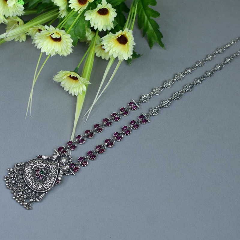 long silver necklace with red oval kemp stones.