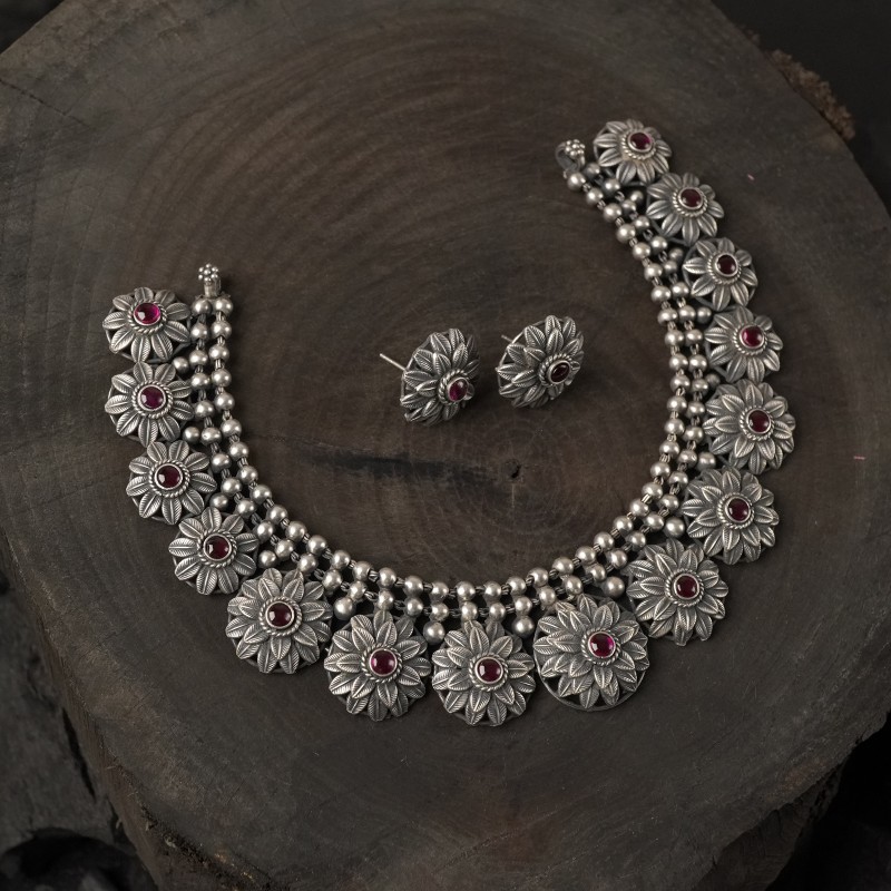 silver chattai necklace with flower pieces.