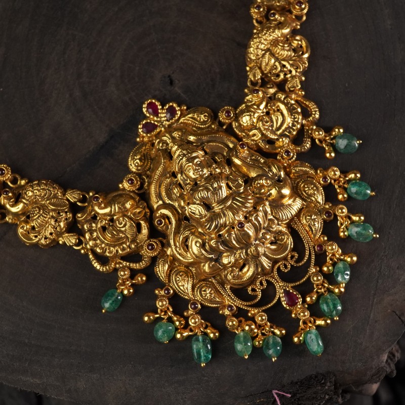 a deeply carved nakashi laxmi pendant studded with AD stones
