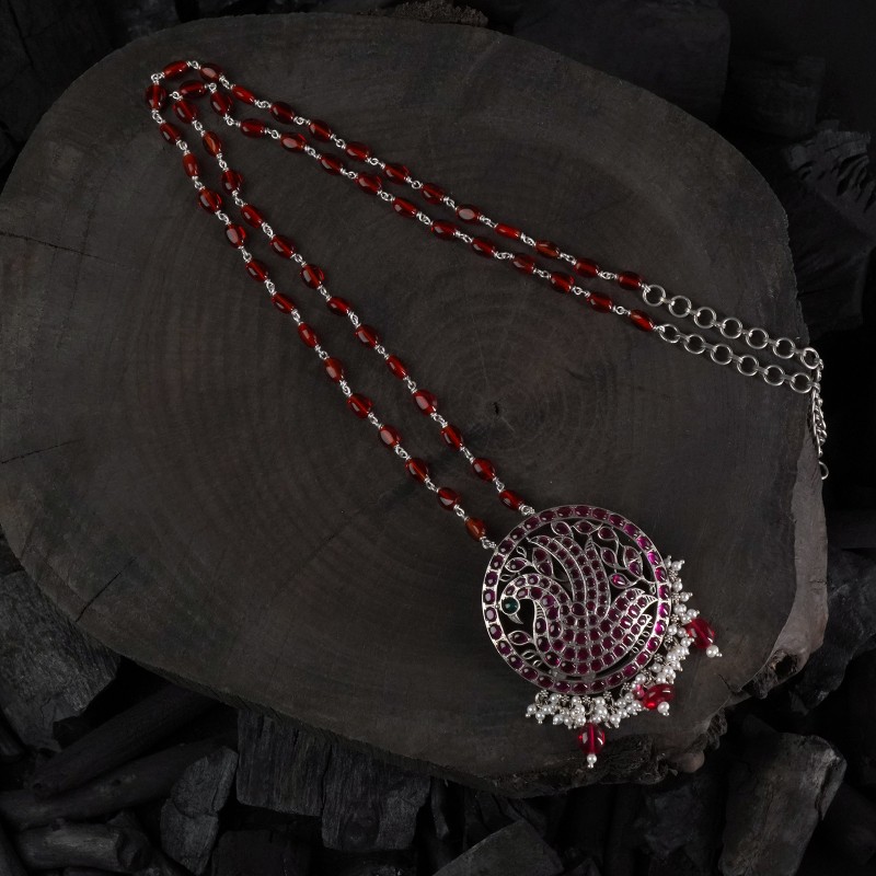 long silver necklace with red kemp stones