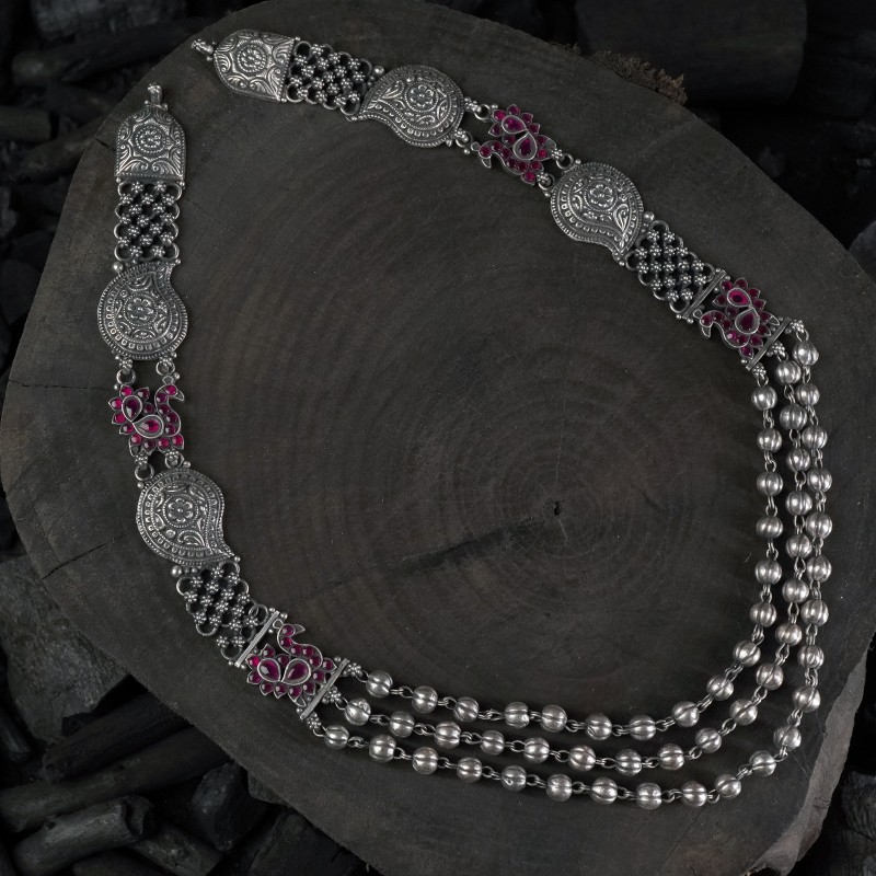 long silver necklace with peacock pieces