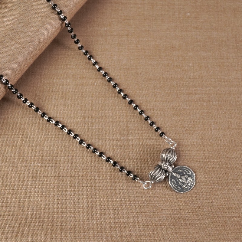 silver mangalsutra with a single laxmi coin