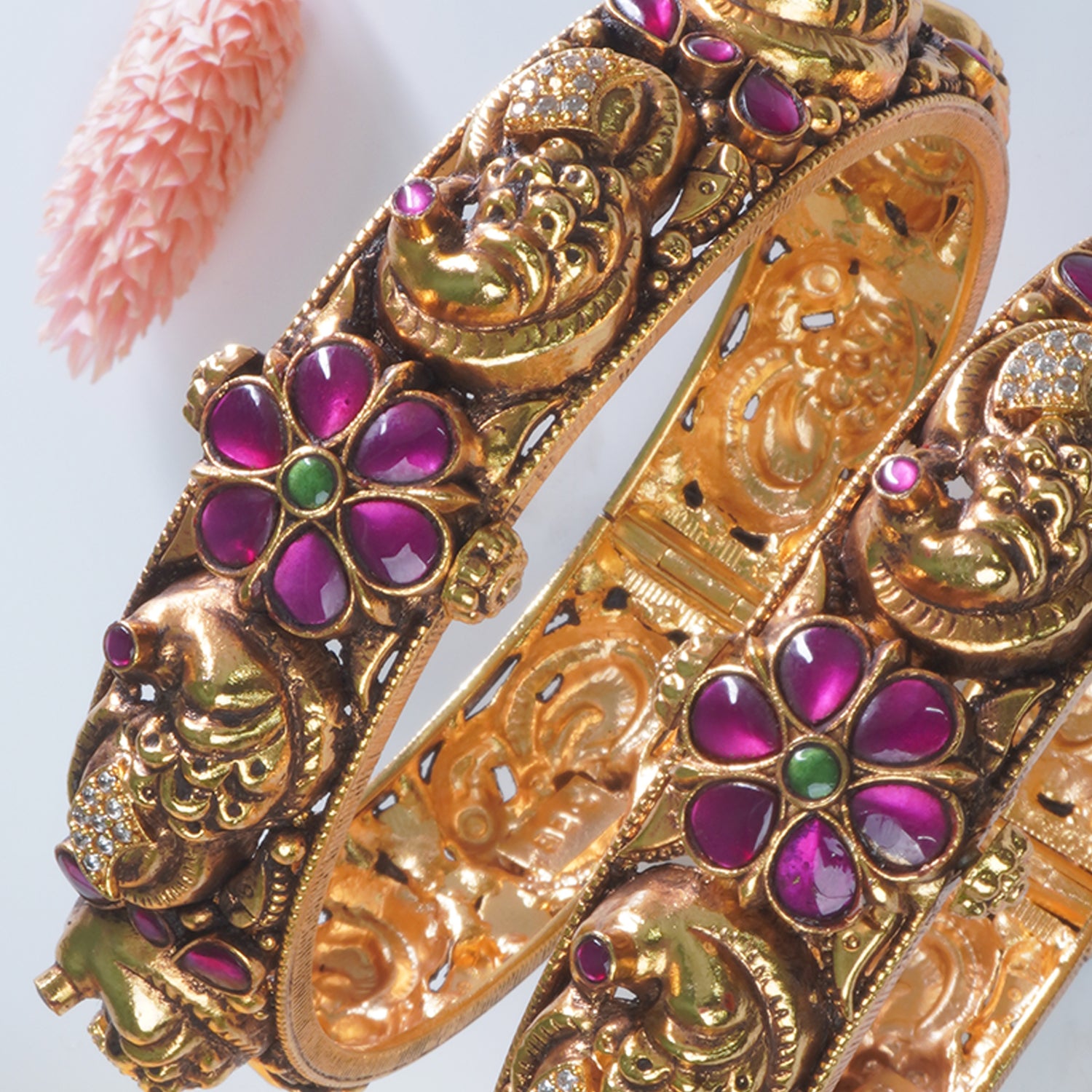 Close-up of peacock carving on 925 silver antique gold plated bangles
