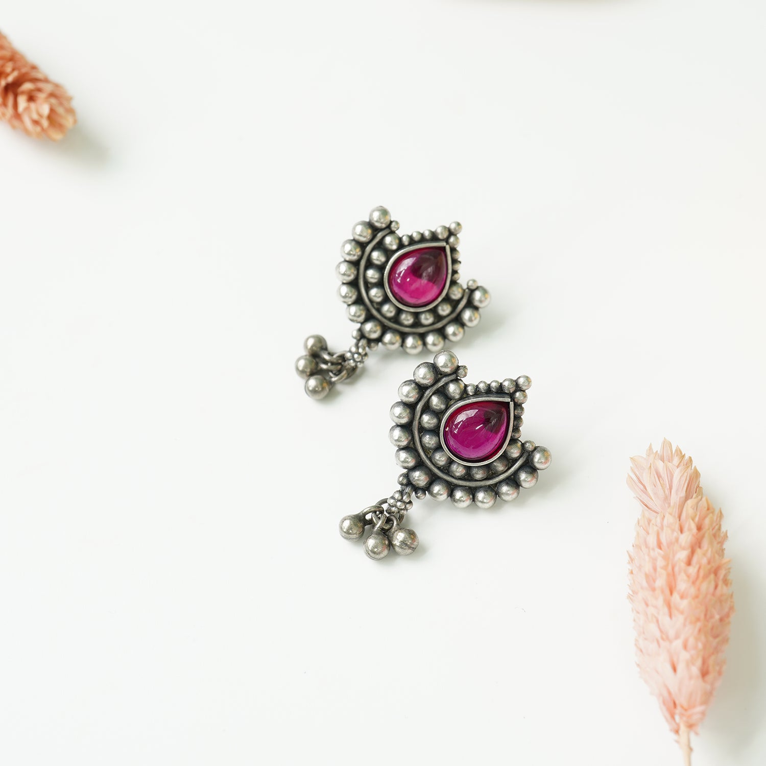 Pure silver oxidised Paan shaped earrings with red Kemp Stone