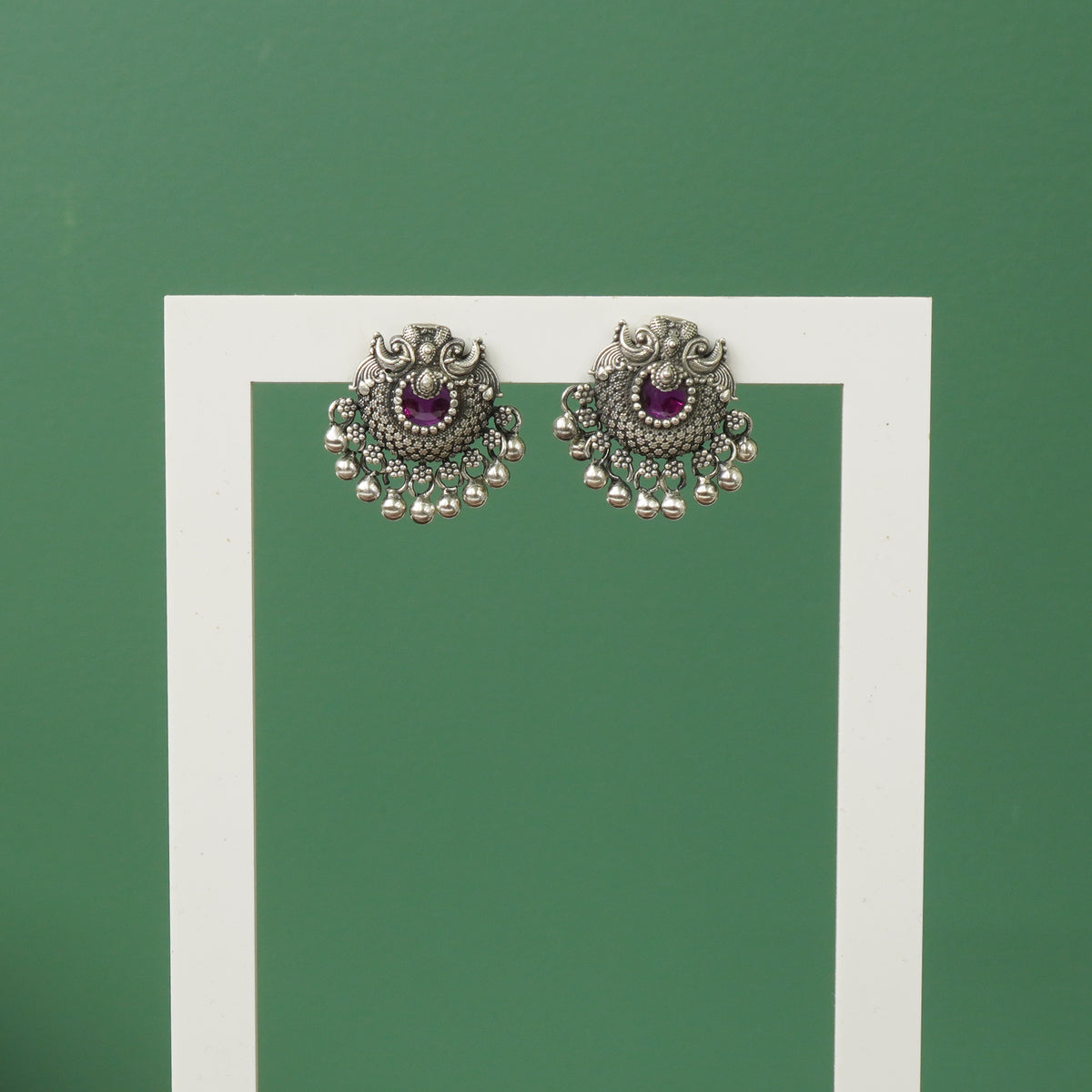 Silver oxidised Peacock earrings with red stones and Ghungroos