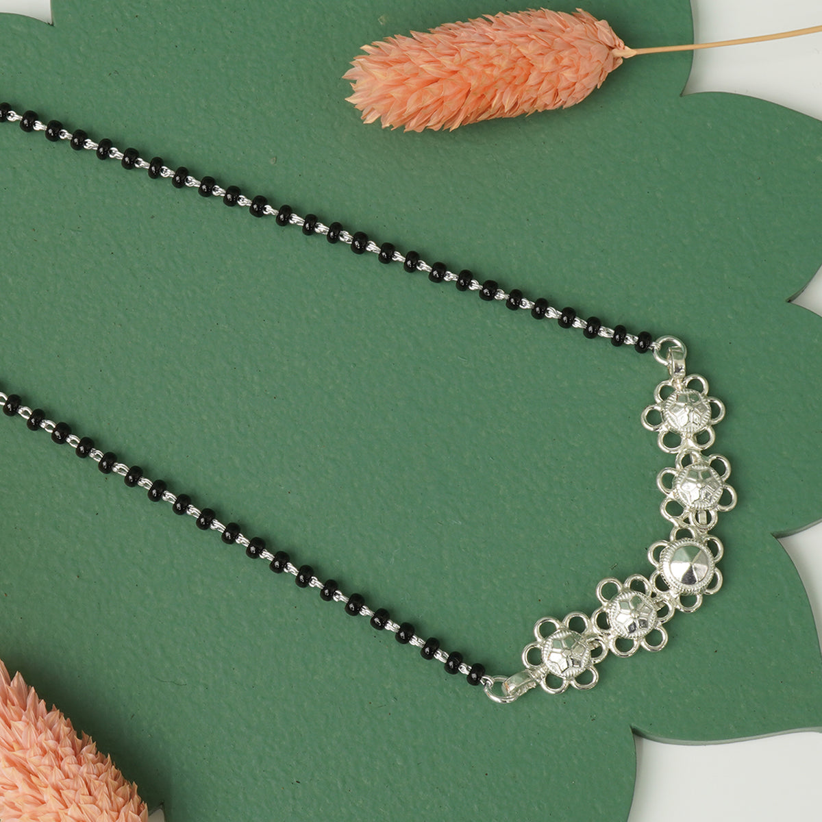 Traditional silver mangalsutra flower detail