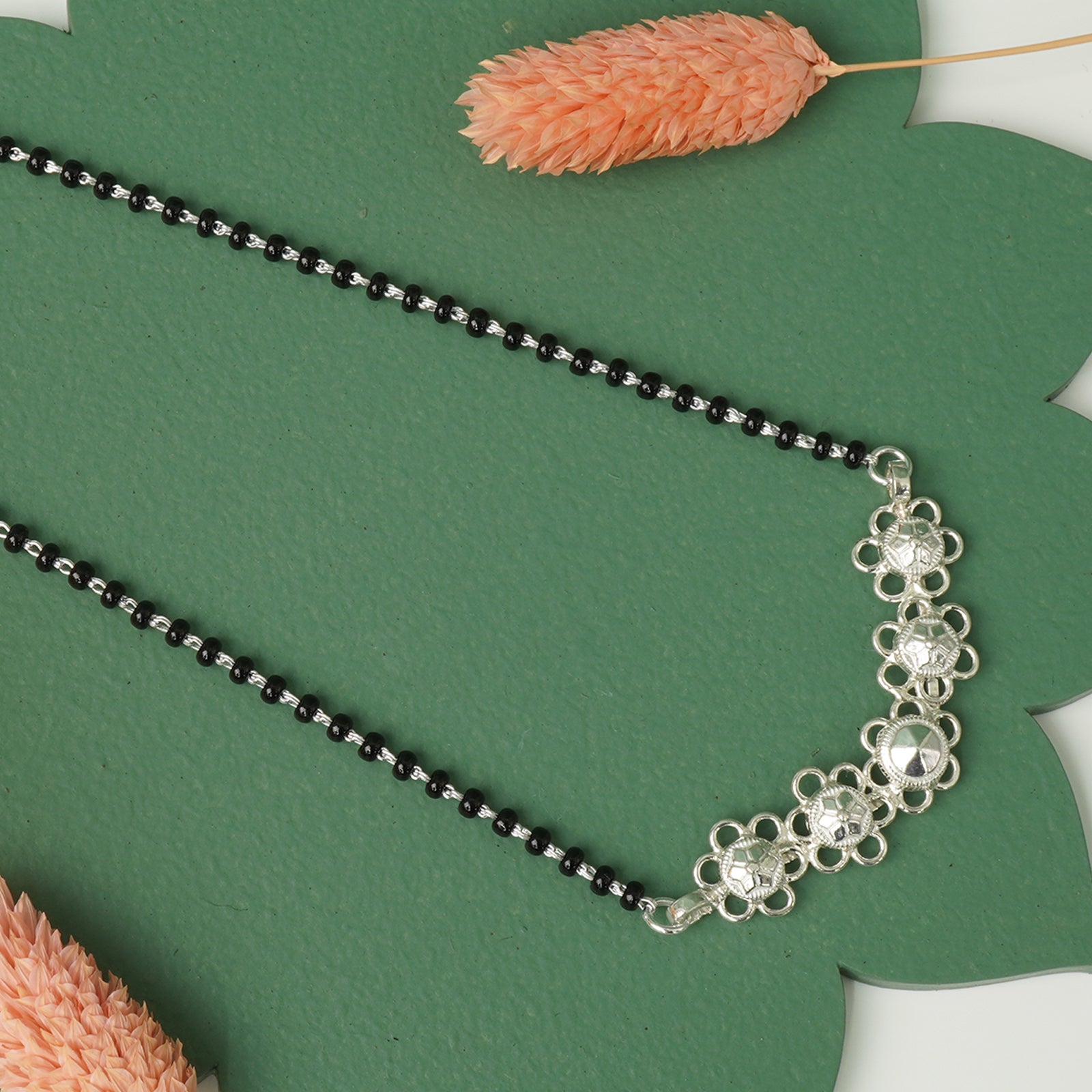 Traditional silver mangalsutra flower detail