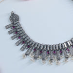 close lookup of silver necklace with intricate detailing