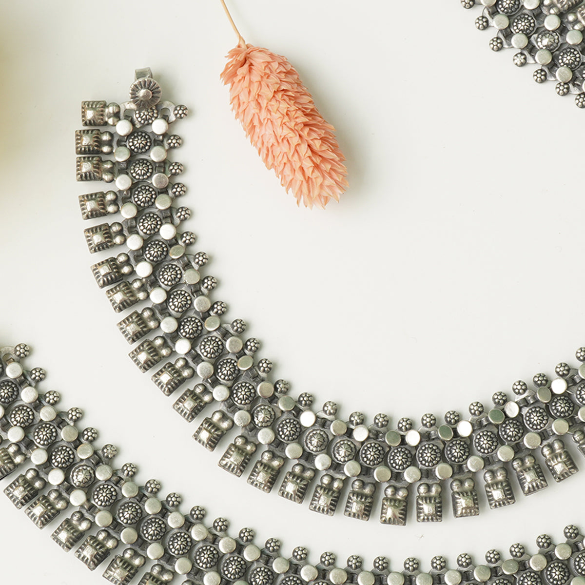 close up of silver payal ke design with ghungroo detailing