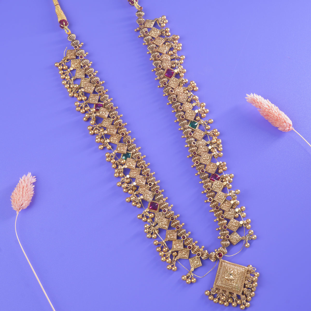 an elegant gold plated silver kolhapuri saaj on a purple background