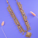 an elegant gold plated silver kolhapuri saaj on a purple background