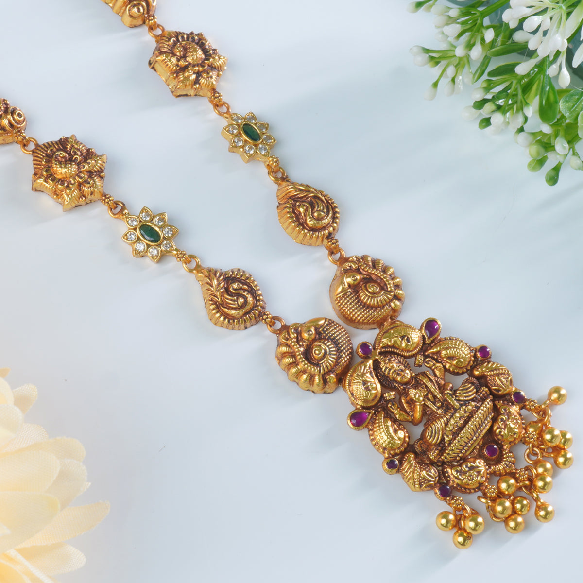 a close up look of laxmi imprint on a silver necklace dipped in gold
