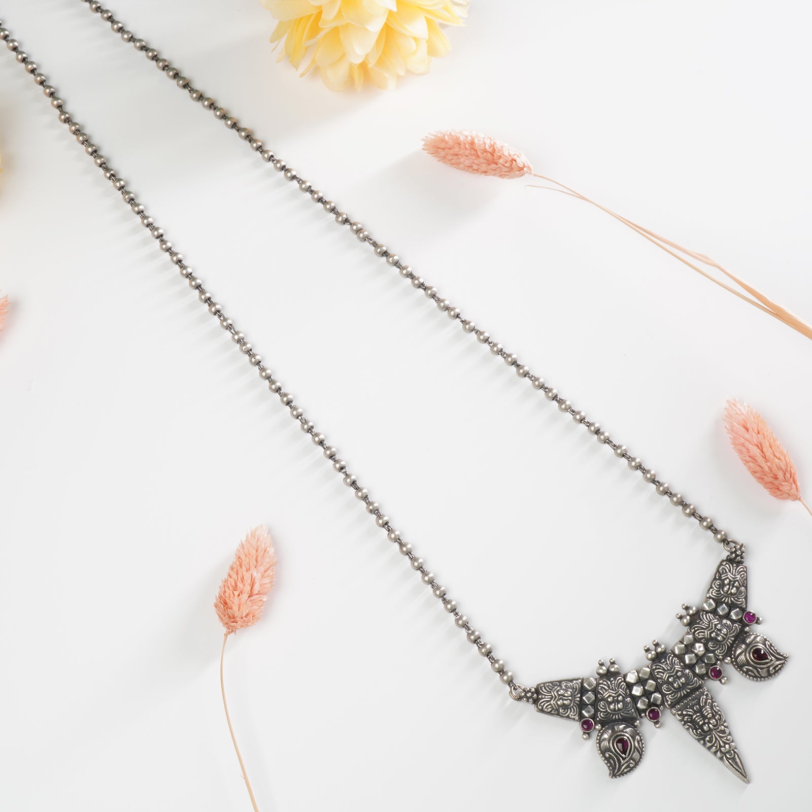 a long silver beads chain necklace with a waghnakhi pendant