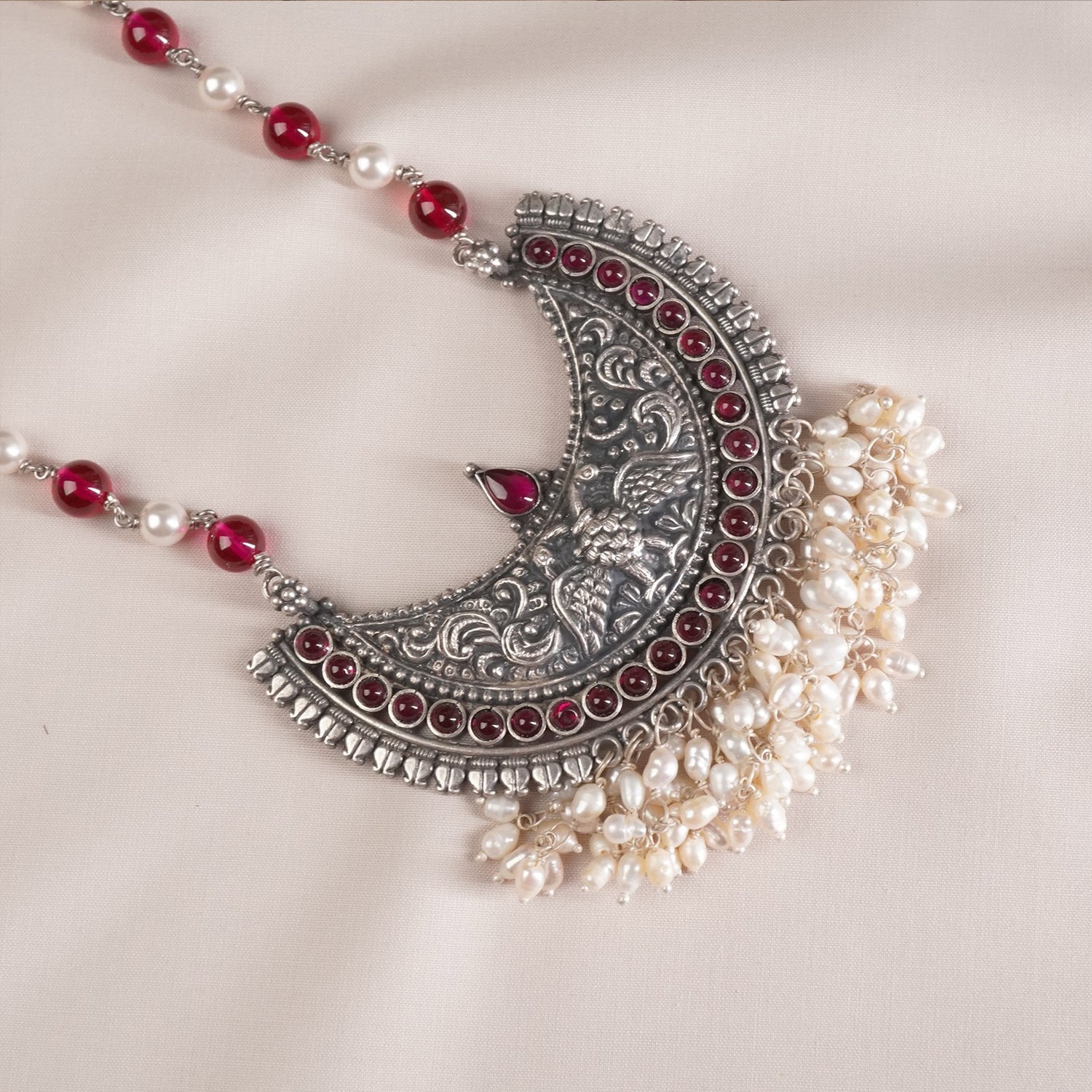 an enchanting silver peacock pendant with pearls