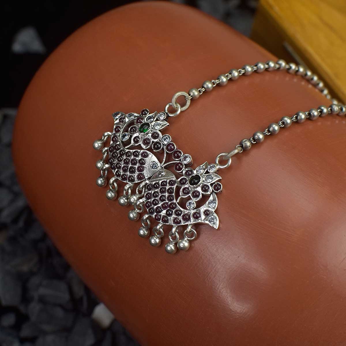 silver ball chain necklace with an kemp studded fish pendant.