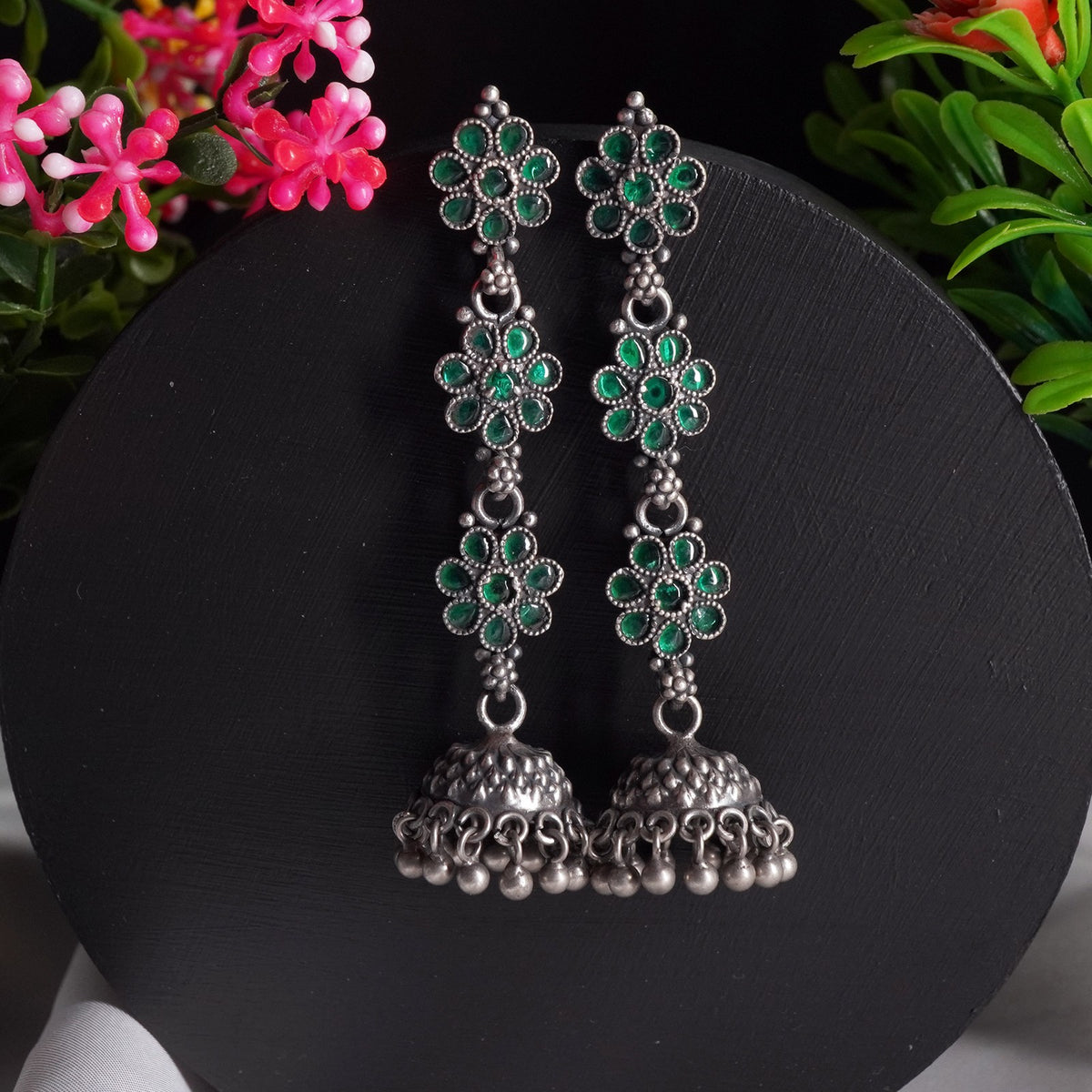 silver jhumkas with green kemp stones