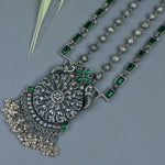 long silver necklace with green kemp stones