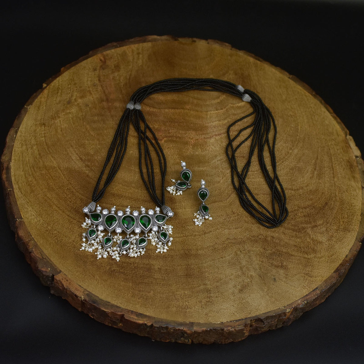 silver tanmani with green emrald stone