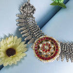 closeup of silver kundan piece in gold plating