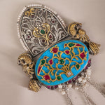 a closeup of silver kundan filigree pendant