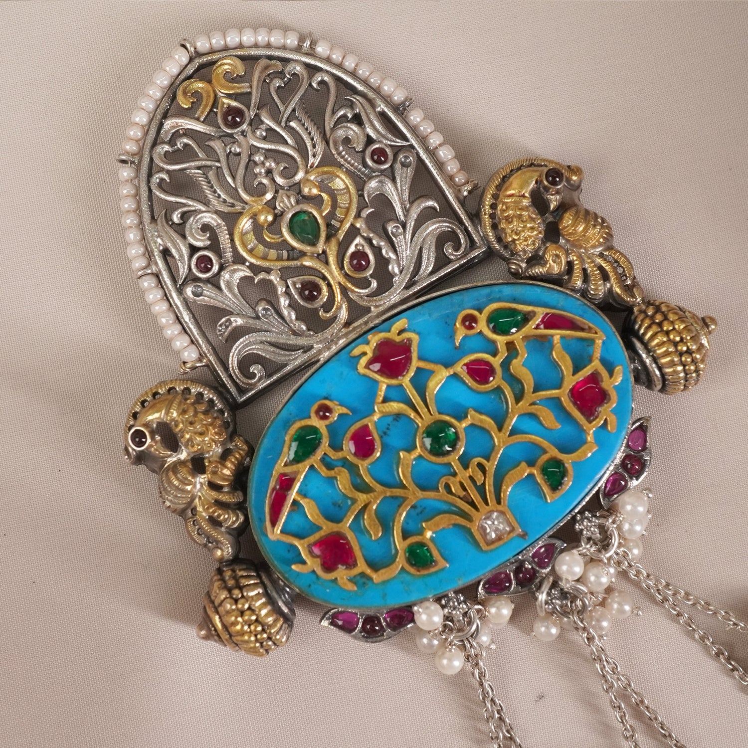 a closeup of silver kundan filigree pendant