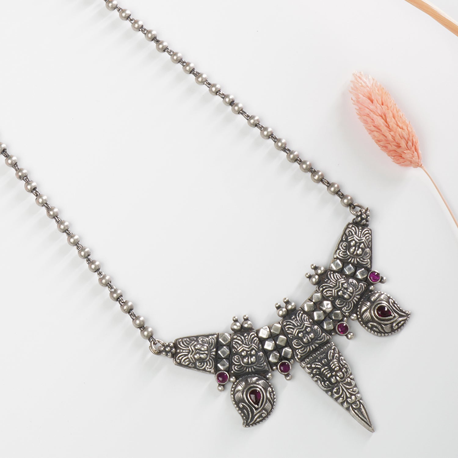 a close up look of handmade silver pendant