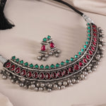 a wide angle shot of silver kolhapuri necklace design with red and green kemp stones